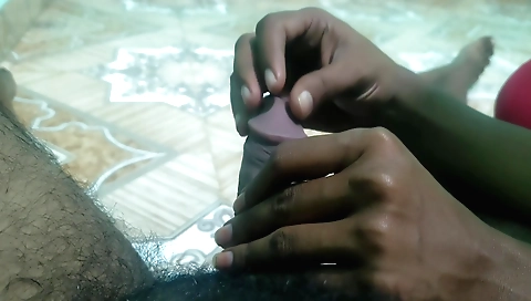 Girlfriend handjob for a guy in the bedroom on a bed