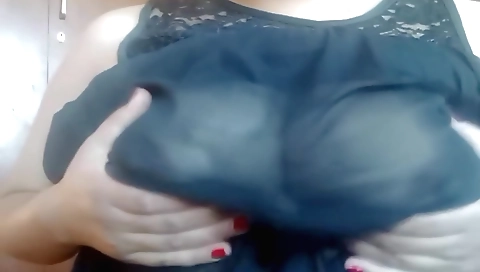 Hot black haired brunette shows her huge boobs on the bed